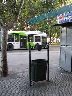 Cubo de basura histrico, al fondo un bus
                        urbano de Santiago con el diseo nuevo tpico en
                        blanco con una banda inclinada en verde