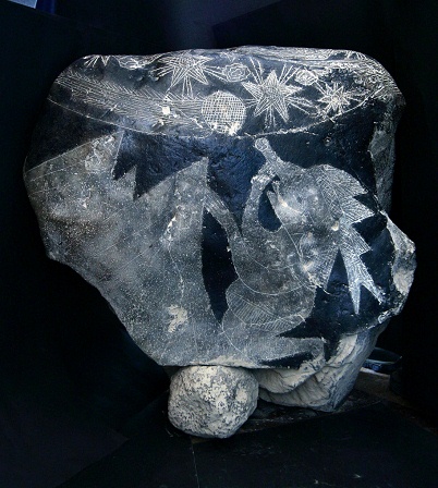 And on the back side of the stone there
                            is a third astronomer on the knees with a
                            telescope in one hand.