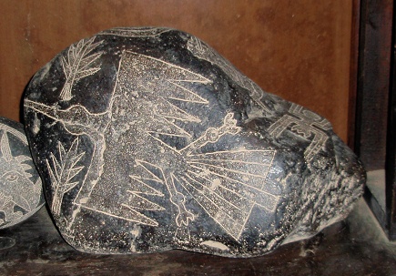 Engraved stone with a Condor eagle of
                            the lines of Nazca and trees, close-up
