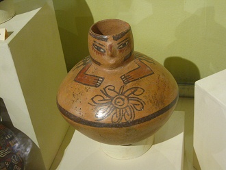 Ceramic vessel with a face in the
                            outlet