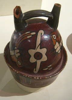 Ceramic bottle of Nazca culture
                                  with hummingbirds (01) flying around a
                                  flower, close-up 01