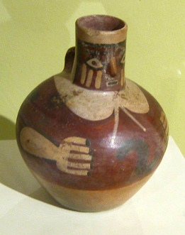 Ceramic jug with a face in the
                                    spout, close-up