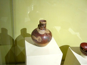 Ceramic jug with a face in the
                                    spout