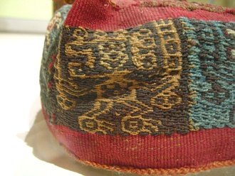 Cap of Wari culture 04, detail
                                  01, a dancing god with antennas